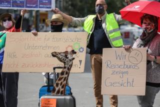 Employees of travel agencies, tour operators and bus companies, wearing face masks and keeping social distancing, demonstrate to demand support and rescue funding in Frankfurt am Main, Germany, 29 April 2020