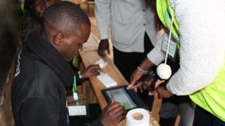 Person wey dem dey assist to cast e vote during di presidential election re-run for inside Kenya.