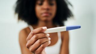 Woman taking a pregnancy test