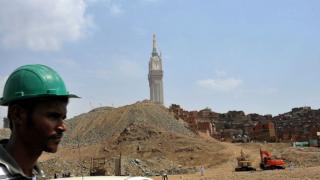 A construction worker is seen at a large housing and hotel construction project, as slums are earmarked for demolition to make way for new buildings around the Mecca's clock tower and Grand Mosque, in the holy city of Mecca, on October 9, 2013.
