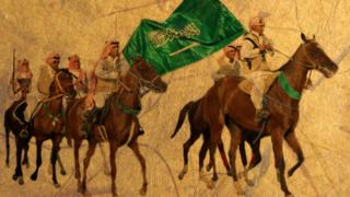 صورة لفرسان يحملون علم السعودية