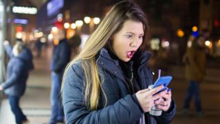 Woman shocked at phone