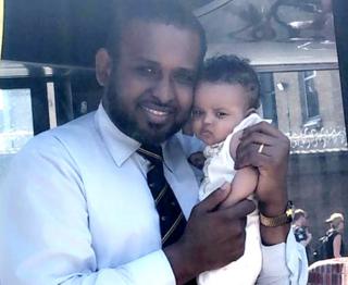Undated handout photo issued by Bishara Maye of her husband bus driver Nadir Nur with his 10-month-old daughter, Sahra Nadir. Nur died in the UK after testing positive for coronavirus