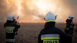Firefighter attacks flames in Poland