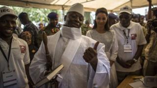 Gambian President Yahya Jammeh gesturing at a polling station