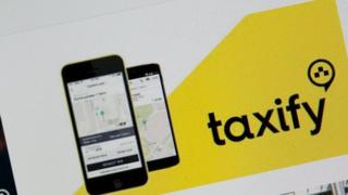 Taxify app on top phone