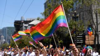 Protesters wave gay pride flag at San Francisco Pride Parade in 2018 on June 24, 2018 in San Francisco, California