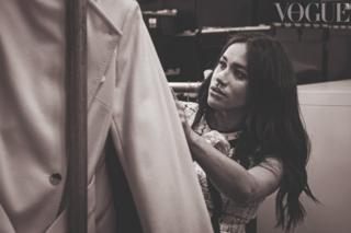 Meghan Markle, the Duchess of Sussex, looking at a rail of clothes