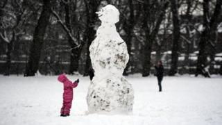 Child and a snowman