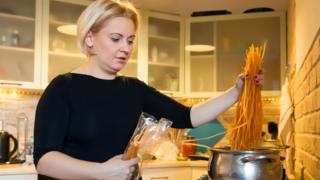 Woman cooks with gas