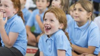 Schoolchildren wearing summer uniforms