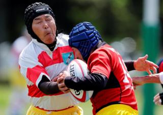 Members of Tokyo's Fuwaku Rugby Club train outdoors