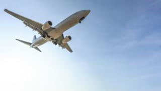 A commercial aeroplane flying in the sky