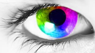 A close up of a human eye with a multi-coloured iris