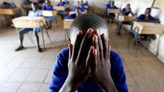 A student dey pray inside classroom before im primary school final national examination for Kiboro Primary school, Nairobi, Kenya - 31 October 2017
