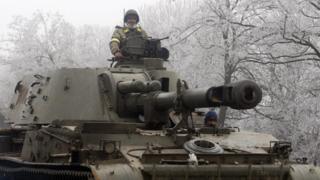 A Ukrainian soldiers sits atop a self-propelled howitzer. File photo