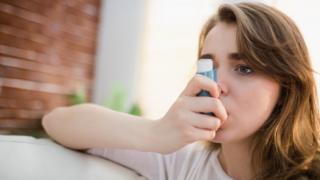 Young woman with an inhaler