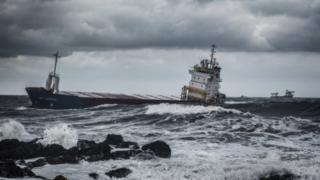 Ship heading for harbour in rough seas