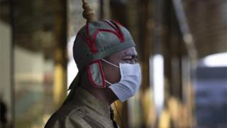 A Cambodian hotel guard wearing a mask stands outside the Nagaworld One hotel in Phnom Penh, Cambodia on February 12, 2020