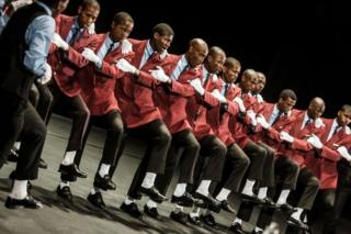 A traditional Isicathamiya group performs at the Natal Playhouse Theatre in Durban on September 23, 2018, during an Isicathamiya competition. - The National Isicathamiya Competition held annually includes over 150 groups competing in the Isicathamiya style, an a capella choral singing style developed in South Africa by migrant Zulu communities.