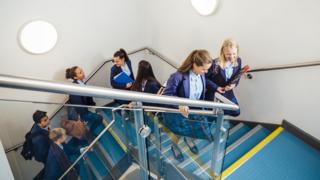 school pupils walking up stairs