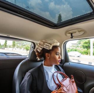 A Nigerian law graduate looks out of a car window