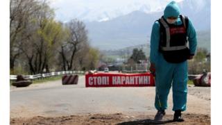 Local authorities control documents as an additional measure to prevent the spread of coronavirus disease (COVID-19) at a checkpoint in the village of Baytik, near Bishkek, Kyrgyzstan,