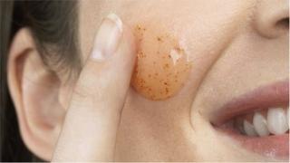Woman using exfoliating gel