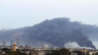 Smoke fumes rise above buildings in the Libyan capital Tripoli, during reported shelling by strongman Khalifa Haftar's forces, on May 9, 2020