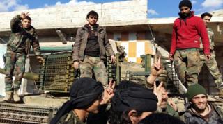 Syrian government forces stand on a tank near the villages of Nubul and Zahra on 2 February 2016