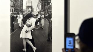 A visitor takes a snapshot of VJ Day in Times Square, New York, 1945