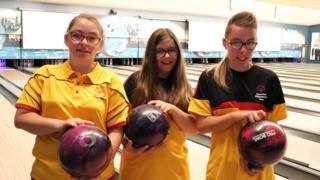 The Delaney sisters holding bowling balls.