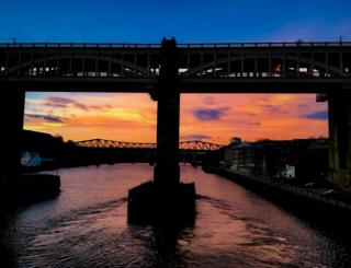 Bridge silhouetted at sunrise