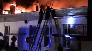 A still image taken from video footage and released by the Russian Emergencies Ministry on 23 September 2016 shows firefighters battling a blaze at a plastics warehouse in Moscow, Russia