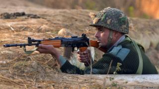 An Indian army soldier takes up position on the perimeter of an airforce base in Pathankot on January 3, 2016.