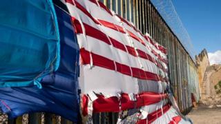 A patchwork representing a US flag hangs on the US-Mexico border in Playas de Tijuana, Baja California State, Mexico, on March 8, 2019