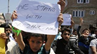 Kashmiri Muslims hold placards and shout slogans during a protest in favour of Islamic scholar and Peace TV founder, Dr. Zakir Naik in Srinagar, the summer capital of Indian Kashmir, 08 July 2016.
