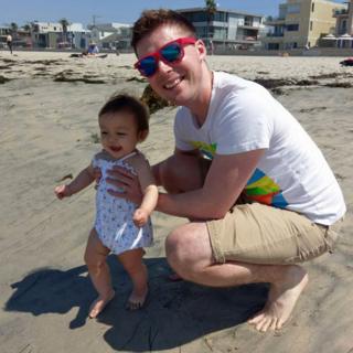 Matthew and his daughter on the beach