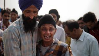 Brother of Indian woman Rajinder Kaur, who was killed in Pakistani shelling wails during her funeral at Khour village in Ramgarh sector, Samba district of Jammu and Kashmir, India, Tuesday, 1 November, 2016