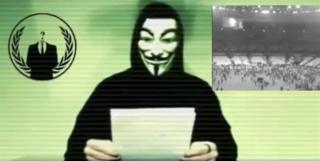 Человек в маске, связанный с Anonymous, делает заявление в этом неподвижном изображении из видео, выпущенного 16 ноября 2015 года