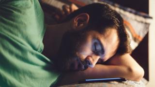 man asleep by phone