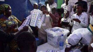 Elections workers count votes after polls closed following Chad's presidential election at a polling station in N'Djamena on 10 April 2016