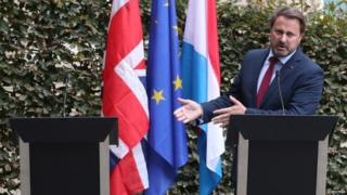 Xaviet Bettel standing next to empty lectern - where Boris Johnson should have been standing