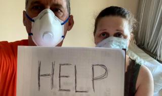 Canadian passengers Chris and Anna Joiner ask for help on board the MS Zaandam, Holland America Line cruise ship, during the coronavirus outbreak, off the shores of Panama City, Panama, 27 March 2020