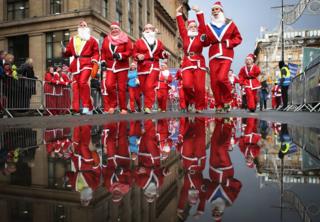 in_pictures More than 7,000 members of the public taking part in Glasgow's annual Christmas Santa dash through the city centre on 8 December , 2019.