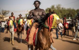 A horseman prepares to parade for the opening ceremony of the Panafrican Film and Television Festival in Ouagadougou, on February 23, 2019