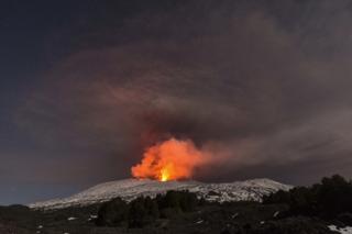 Snow-covered Mount Etna, Europe's most active volcano, spews lava during an eruption in the early hours of 16 March 2017.