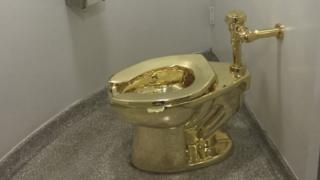 Gold toilet by Maurizio Cattelan