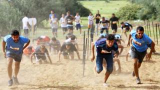 Libyan people wey dey race, from across Libya, for inside one 4km obstacle race, for di Tripoli wey be capital city on October 28, 2017