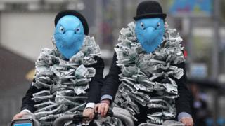 Protestors dressed as eagles protest against Barclays' pay arrangements at the company's 2012 AGM